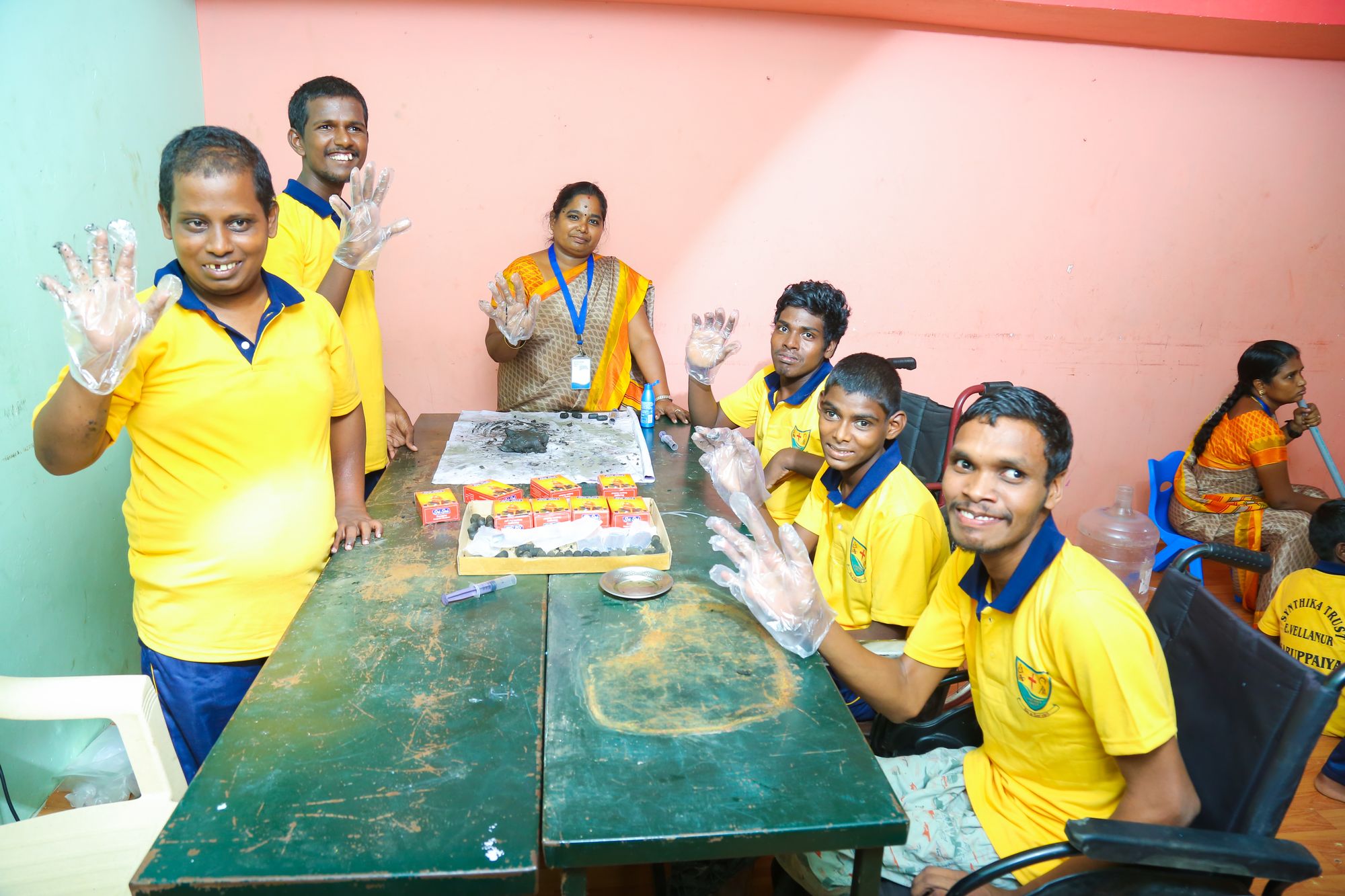 Young adults waving during a craft session